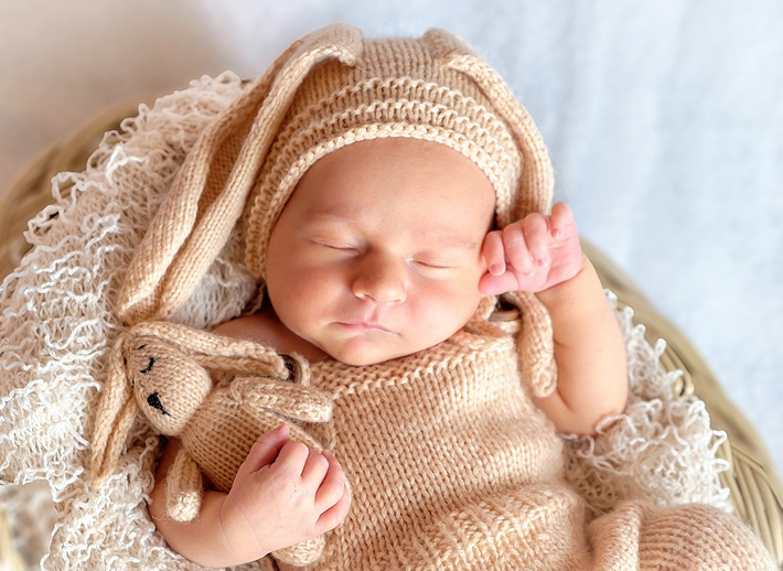 White nursery room furniture including cot, wardrobe and changing station