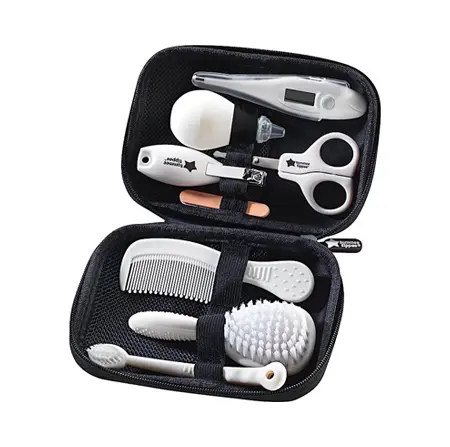 Compact baby grooming kit with nail clippers, thermometer, brush, and other essentials